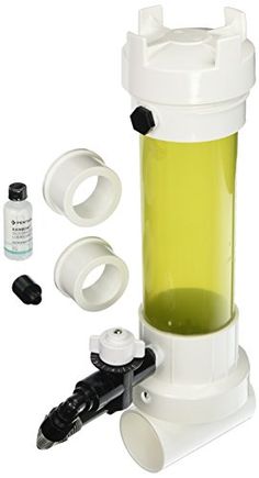 a white and green blender sitting next to two bottles with black caps on it