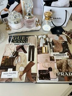 the contents of a purse are displayed on a table next to other items, including perfumes and handbags