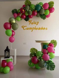 some balloons are hanging on the wall in front of a sign that says feliy cumplenher