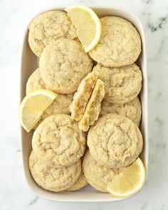 lemon cookies in a baking dish with sliced lemons