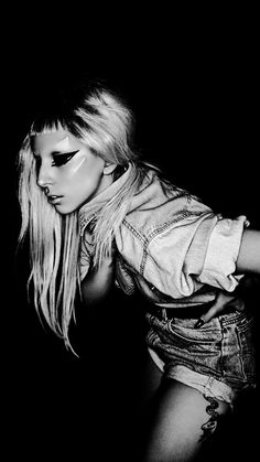 black and white photograph of a woman with makeup on her face posing for the camera