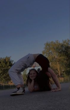 two people are standing on their backs in the street