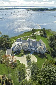 this is an aerial view of the house and its surrounding grounds, with boats in the water