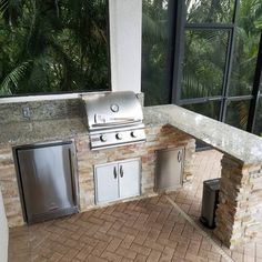 an outdoor kitchen with stainless steel appliances