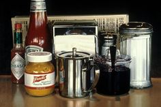 there are many items on the table including coffee, juicer, and toaster