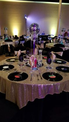 the table is set up for a party with disco ball decorations