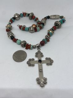 "This piece is so beautiful. It is a genuine, vintage, Taxco multi stone and sterling silver cross necklace. The necklace is 22 inches. The necklace features gorgeous, natural blue turquoise, red coral, carnelian, black onyx and sterling silver beads with a huge stamped sterling silver and black onyx cross. The stones are nuggets, round beads, rondelle beads. The sterling silver beads are stunning with etchings, including flowers, scrollwork, ribbed and other designs; some beads are shaped like Handmade Southwestern Cross Necklace, Southwestern Handmade Cross Necklace, Silver Southwestern Multi-stone Turquoise Necklace, Southwestern Silver Turquoise Multi-stone Necklace, Silver Bohemian Beaded Necklaces With Multi-stone, Silver Bohemian Beaded Necklace With Multi-stone, Silver Multi-stone Beaded Bohemian Necklace, Bohemian Silver Multi-stone Beaded Necklaces, Sterling Silver Cross Necklace