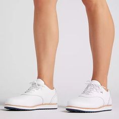 a woman's legs in white tennis shoes