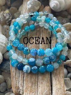 1 Ocean Bracelet Our healing gemstone blue agate bracelet.  Like the healing powers of the ocean.  These gemstones encourage wisdom, peace and calm. **message us if another size is needed** AGATES Wisdom, calms, healing inner anger and tension, power and strength. We love the peace and beauty of the ocean and nature.  We enjoy making each piece an original design.     Each order is packaged as a special gift ready to give away or keep for yourself.  Every order is very special to us! 🐚Designing with inspiration from the Peace the beach brings. 🐚We guarantee all our jewelry and will always repair our pieces for free no questions asked! 🐚We package each order like a special gift. 🐚Free US shipping Turquoise Healing Bracelet With 108 Beads, Agate Beaded Bracelets For Healing, Blue Beaded Bracelets With Natural Stones For Healing, Healing Agate Beaded Bracelets, Blue Adjustable Stretch Bracelet For Healing, Adjustable Agate Stretch Bracelet For Healing, Blue Gemstone Stretch Bracelet As Gift, Agate Gemstone Stretch Bracelet For Healing, Spiritual Agate Stretch Bracelet With Gemstone Beads