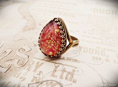 An elegant adjustable Victorian ring, made from a filigree ring base and a vibrant rose pink fire opal cabochon. It makes the perfect handmade women's gift for anyone who loves vintage style jewelry. The cabochon is a rare vintage Cherry Brand Rose Pink Fire Opal cabochon in an 18x13mm pear shape, set in an adjustable filigree setting that shapes easily to fit most sizes small to large. I only have this stone in lead/nickel free antique bronze plated brass at this time. It has a large amount of Pink Fire, Victorian Ring, Vintage Cherry, Fire Opal Ring, Victorian Rings, Vintage Style Jewellery, Glass Rings, Deco Jewelry, Filigree Ring