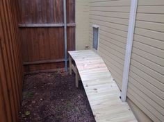 a wooden bench sitting next to a building