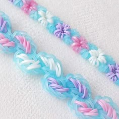 two pieces of blue, pink and white braiding