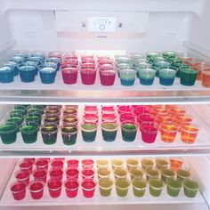 the shelves are filled with different colored cups