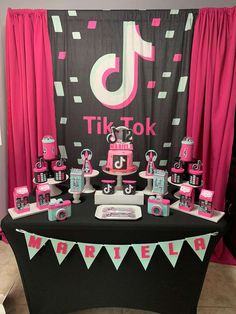 a pink and black birthday party with decorations