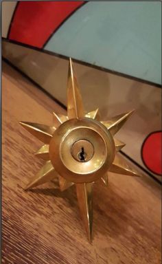 a metal object sitting on top of a wooden table