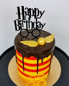 a harry potter themed birthday cake on a black and gold plated serving platter