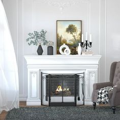 a living room with a fireplace, chair and pictures on the wall in front of it