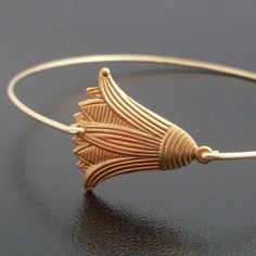 "A brass Tulip in an antique gold finish has been transformed into a dainty & delicate tulip bangle bracelet with choice of brass or 14k gold filled bangle band. I can also make this tulip bracelet in a silver tone finish with bangle band choice of silver filled or sterling silver for your tulip jewelry. This stacking bangle looks great together with others from my collection as you can see from the last 2 pictures. Have fun stacking them in 2, 3, 4 or more for the ultimate layered look! ADD Elegant Bronze Bracelets For Wedding, Adjustable Bronze Bracelets For Wedding, Adjustable Bronze Bracelet For Wedding, Adjustable Brass Bangle For Wedding, Adjustable Flower-shaped Bangle For Weddings, Adjustable Flower Bangle For Wedding, Bridesmaid Flower Bracelet, Tulip Bracelet, Tulip Jewelry