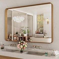 a bathroom with a sink, mirror and flowers on the counter