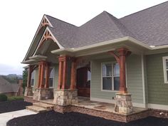 a house with stone pillars and columns in the front yard