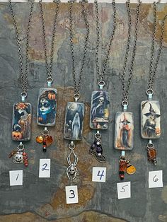 there are many different necklaces hanging on the wall with price tags attached to them