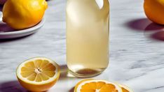 a bottle of lemonade next to sliced oranges