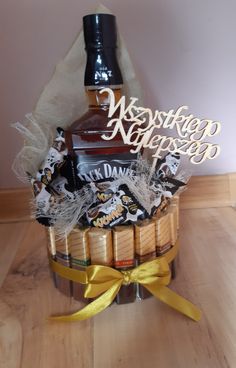 a bottle of whiskey sitting on top of a wooden table next to some candies