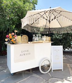 an ice cream cart is decorated with flowers