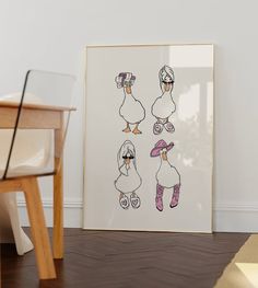 an art piece with three ducks in boots and one duck wearing a hat is on the floor next to a chair