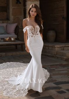 a woman in a white wedding dress standing on a stone floor with her hands behind her back