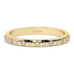 a yellow gold wedding band with five diamonds