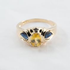 Hi. This is a very pretty blue and yellow sapphire ring with diamond accents in 14k yellow gold. It is marked 14k on the inside of the ring. The diamond accents are real. The yellow gemstone measures 5x7mm and oval in shape. The blue sapphires are pear shape. The ring finger size is 8. Sorry, we do not resize rings. The weight of the ring with the stones is 3.5 grams. This item will have insurance and signature confirmation. Thanks for looking. Yellow Oval Topaz Ring In 14k Gold, Oval Yellow Sapphire Ring With Center Stone, Yellow Oval Birthstone Promise Ring, Yellow Sapphire Ring With Oval Shape And Accent Stones, Oval Yellow Gold Birthstone Anniversary Ring, Oval Yellow Birthstone Anniversary Ring, Yellow Oval Birthstone Anniversary Ring, Oval Yellow Topaz Ring In 14k Gold, Yellow Sapphire Ring With Accent Stones For Promise