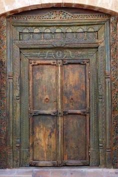 an old wooden door with intricate carvings on it