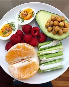 a white plate topped with fruits and vegetables