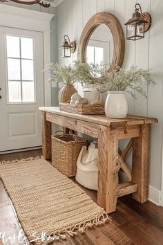 a wooden table with baskets and vases on it in front of a white door