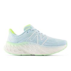 a women's running shoe in light blue and white with neon green accents on the sole