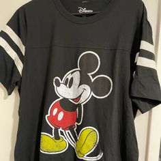 Mickey Mouse Shirt Never Worn Spring Mickey Mouse Crew Neck T-shirt, Sporty Mickey Mouse Crew Neck Top, Casual Mickey Mouse T-shirt For Spring, Black Mickey Mouse Short Sleeve Shirt, Black Short Sleeve Mickey Mouse Shirt, Mickey Mouse Crew Neck T-shirt For Spring, Spring Mickey Mouse Short Sleeve Top, Retro Black Shirt For Spring, Black Mickey Mouse Short Sleeve T-shirt