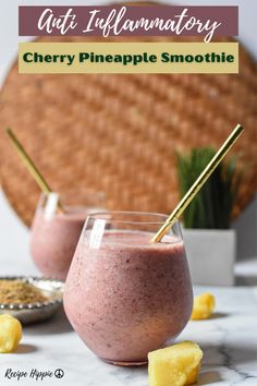 two glasses filled with smoothie sitting on top of a table