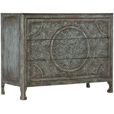 an ornate wooden chest with carvings on the front and sides, painted in grey tones