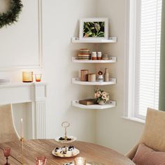 a dining room table with plates and cups on it in front of a fire place