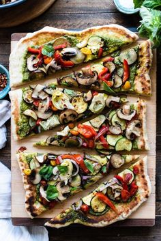 sliced pizza with vegetables and sauces on a cutting board