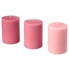 three pink candles sitting next to each other