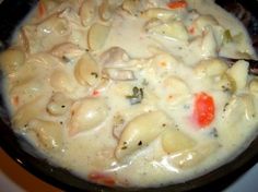 a pot filled with pasta and vegetables on top of a stove