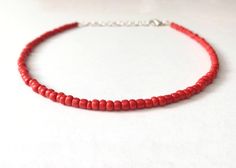 This red bead necklace is 100% handmade with beautiful glass seed beads. It can be made either 14, 16, 18, or 20 inches long, and each necklace comes with additional extender chain, making it easily adjustable. This necklace goes great with so many outfits- dress it up for a fancier event, or wear it with jeans and a t-shirt. It also makes a simple yet amazing gift for a family member, friend or loved one! Handmade Red Beaded Choker Necklace, Red Beaded Choker Necklaces For Festival, Red Beaded Choker Necklace For Festivals, Handmade Adjustable Red Choker, Red Bead Choker For Festivals, Red Beaded Choker Necklace As Gift, Red Beaded Choker Necklace For Gift, Handmade Red Choker For Beach, Adjustable Red Choker With Tiny Beads