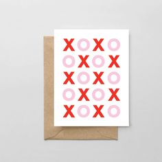 a greeting card with pink and red xo symbols on the front, against a white background