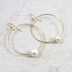 "Gold Hoop Pearl Earrings~ These elegant gold hoop earrings with a freshwater white pearl will look great for any occasion. Hammered and polished to a beautiful shine. Hoops are approx. 1.5\" Model wearing similar design~ https://www.etsy.com/listing/111095394/white-pearl-earrings-gold-hammered-hoops?ref=shop_home_active_22 Shop~ http://www.etsy.com/shop/HanaMauiCreations?ref=pr_shop_more International buyers please read our shipping policies before ordering~ POLICIES~ https://www.etsy.com/shop/ Hoop Pearl Earrings, Hammered Hoop Earrings, White Pearl Earring, Gold Pearl Earrings, White Freshwater Pearl, June Birthstone, Earrings White, Jewelry Wedding, June Birth Stone