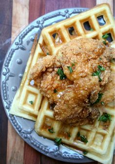 fried chicken and waffles on a plate with grated parmesan cheese