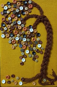 an art project made out of buttons and rope on a yellow background with the word love spelled