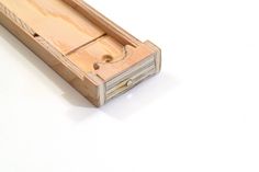 an empty wooden box sitting on top of a white table