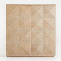 a wooden cabinet with geometric designs on the front and sides, against a white background